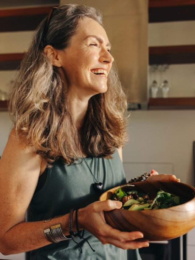 Aging,Woman,Smiling,Happily,While,Holding,A,Buddha,Bowl,In